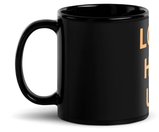 A black coffee mug with orange letters on it

Description automatically generated with low confidence